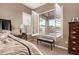 A view to the pool from the main bedroom through open shutters, showcasing outdoor amenities and natural light at 25845 N 44Th Ave, Phoenix, AZ 85083