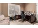 Study room features a large window with wood shutters, carpet, and built-in desk and cabinets at 25845 N 44Th Ave, Phoenix, AZ 85083