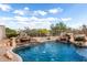 Beautiful pool with rock waterfalls and desert landscaping at 25845 N 44Th Ave, Phoenix, AZ 85083
