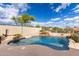 Sparkling backyard pool with rock waterfall feature and mature landscaping at 25845 N 44Th Ave, Phoenix, AZ 85083