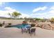 Inviting backyard pool with rock features, patio, and desert landscaping at 25845 N 44Th Ave, Phoenix, AZ 85083