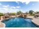 Backyard pool features stone waterfalls, desert landscaping and patio seating at 25845 N 44Th Ave, Phoenix, AZ 85083