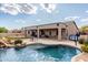 Backyard pool and patio featuring desert landscape, waterfall, and desert views at 25845 N 44Th Ave, Phoenix, AZ 85083