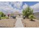 Relaxing backyard seating area with pavers, desert landscaping, and ample space for outdoor enjoyment at 25946 W Cat Balue Dr, Buckeye, AZ 85396
