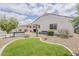 Lush backyard with artificial turf, desert landscaping, pavers and modern outdoor storage at 25946 W Cat Balue Dr, Buckeye, AZ 85396