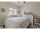 Comfortable bedroom with a ceiling fan, neutral walls, and natural light at 25946 W Cat Balue Dr, Buckeye, AZ 85396