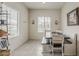 Bright dining area features bench seating, neutral paint, and modern farmhouse design at 25946 W Cat Balue Dr, Buckeye, AZ 85396