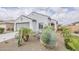 Charming single-story home featuring desert landscaping, a two-car garage, and a neutral-toned exterior at 25946 W Cat Balue Dr, Buckeye, AZ 85396
