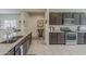 Well-equipped kitchen with granite countertops, stainless steel appliances, and dark wood cabinetry at 25946 W Cat Balue Dr, Buckeye, AZ 85396
