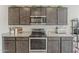Close-up of the kitchen with modern appliances, stylish cabinets, and beautiful granite countertops at 25946 W Cat Balue Dr, Buckeye, AZ 85396