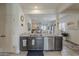 Open-concept kitchen featuring granite countertops, a stainless steel sink, and ample cabinet space at 25946 W Cat Balue Dr, Buckeye, AZ 85396