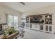 Inviting living room featuring a large entertainment center and a sliding glass door to the outside at 25946 W Cat Balue Dr, Buckeye, AZ 85396