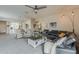 Open-concept living room with plush seating, a ceiling fan, and seamless integration with the dining area at 25946 W Cat Balue Dr, Buckeye, AZ 85396