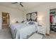 Spacious main bedroom featuring a ceiling fan, area rug, and a large art piece at 25946 W Cat Balue Dr, Buckeye, AZ 85396