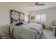 Calming main bedroom featuring a ceiling fan, area rug, large art pieces, and a window at 25946 W Cat Balue Dr, Buckeye, AZ 85396