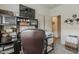 Functional office space with built-in shelves, a desk, a TV, printer and ample storage for organization at 25946 W Cat Balue Dr, Buckeye, AZ 85396