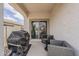 Covered patio with comfortable seating and a grill, perfect for outdoor dining and entertainment at 25946 W Cat Balue Dr, Buckeye, AZ 85396