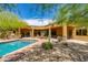 Desert backyard featuring a pool, patio, lush desert landscaping and an outdoor grilling area for entertaining at 26156 N 88Th Way, Scottsdale, AZ 85255