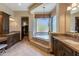 Luxury bathroom with dual vanities, a soaking tub on a raised platform, and a separate walk-in closet at 26156 N 88Th Way, Scottsdale, AZ 85255