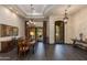 Elegant dining room with dark wood floors, a chandelier, and access to the outdoor patio at 26156 N 88Th Way, Scottsdale, AZ 85255