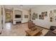 Inviting hallway with neutral tones, an accent chair, and a decorative coffee table with a curated display of photographs at 26156 N 88Th Way, Scottsdale, AZ 85255