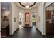 Elegant hallway featuring dark wood floors, custom lighting, and access to the rest of the home at 26156 N 88Th Way, Scottsdale, AZ 85255