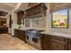 Chef's kitchen boasts a stainless steel range, granite countertops, and custom cabinets at 26156 N 88Th Way, Scottsdale, AZ 85255