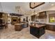 Open-concept kitchen with custom cabinets, granite countertops, stainless steel appliances, and travertine floors at 26156 N 88Th Way, Scottsdale, AZ 85255