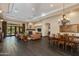 Open-concept living room boasts dark wood floors, a stone fireplace, and seamless access to the outdoor patio at 26156 N 88Th Way, Scottsdale, AZ 85255