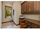 Office with wood cabinetry, tile floors, and a window providing natural light and a view of the outdoors at 26156 N 88Th Way, Scottsdale, AZ 85255