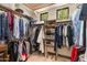 Walk-in closet with clothing racks and upper storage, providing ample space for a well-organized wardrobe at 26156 N 88Th Way, Scottsdale, AZ 85255