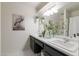 Bathroom with dual sinks, marble countertops, and decorative plants, creating a spa-like retreat at 2938 S Country Club Way, Tempe, AZ 85282