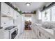 Open kitchen featuring white cabinets, modern appliances, and views into the dining area for easy entertaining at 2938 S Country Club Way, Tempe, AZ 85282