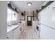 Bright kitchen with white cabinetry, marble countertops, tile floor, and decorative plants, creating a welcoming space at 2938 S Country Club Way, Tempe, AZ 85282