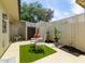 Cozy enclosed patio with artificial turf, dining set, privacy walls, and desert landscaping at 2938 S Country Club Way, Tempe, AZ 85282