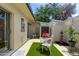 Enclosed patio features artificial turf, outdoor dining set, privacy walls and desert landscaping at 2938 S Country Club Way, Tempe, AZ 85282
