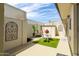 Cozy patio area with white walls, turf, decorative panels, outdoor seating, and a sunny spot at 2938 S Country Club Way, Tempe, AZ 85282