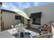 Private patio with outdoor dining table and chairs, adjacent to the front door at 2938 S Country Club Way, Tempe, AZ 85282
