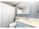 A well lit bathroom with white shower curtain, a vanity with cabinet, and blue walls at 3134 E Mckellips Rd # 139, Mesa, AZ 85213