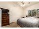 A cozy bedroom featuring a bed, dresser, and a window letting in natural light and outdoor views at 3134 E Mckellips Rd # 139, Mesa, AZ 85213