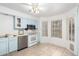 A bright kitchen with light blue cabinetry, stainless steel appliances, and an eat-in area next to a window at 3134 E Mckellips Rd # 139, Mesa, AZ 85213