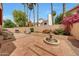 Spacious backyard featuring a fountain, stone-paved patio, mature landscaping, and privacy wall at 3234 E Briarwood Ter, Phoenix, AZ 85048