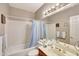 Neutral bathroom featuring shower-tub combo, bright lighting, framed mirror, and updated fixtures at 3234 E Briarwood Ter, Phoenix, AZ 85048