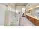 Bathroom with a large tub, double sink vanity, and arched window providing natural light at 3234 E Briarwood Ter, Phoenix, AZ 85048