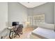 Bedroom with gray walls, wood look tile flooring, and a gaming setup at 3234 E Briarwood Ter, Phoenix, AZ 85048
