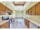 Spacious kitchen with stainless steel appliances, wood cabinetry, and a sunny view of the backyard at 3234 E Briarwood Ter, Phoenix, AZ 85048