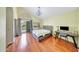 Main bedroom with wood floors, backyard access, chandelier, vaulted ceiling, and gray furniture at 3234 E Briarwood Ter, Phoenix, AZ 85048