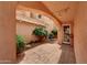 Covered patio with string lights, tiled floor, and access to a well-maintained backyard with greenery at 3234 E Briarwood Ter, Phoenix, AZ 85048