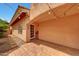 Charming covered patio with tiled flooring, string lights, and an inviting entrance to the backyard at 3234 E Briarwood Ter, Phoenix, AZ 85048