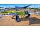 Community playground with colorful slides, climbing structures, and a soft landing surface at 3524 N 103Rd Ave, Avondale, AZ 85392